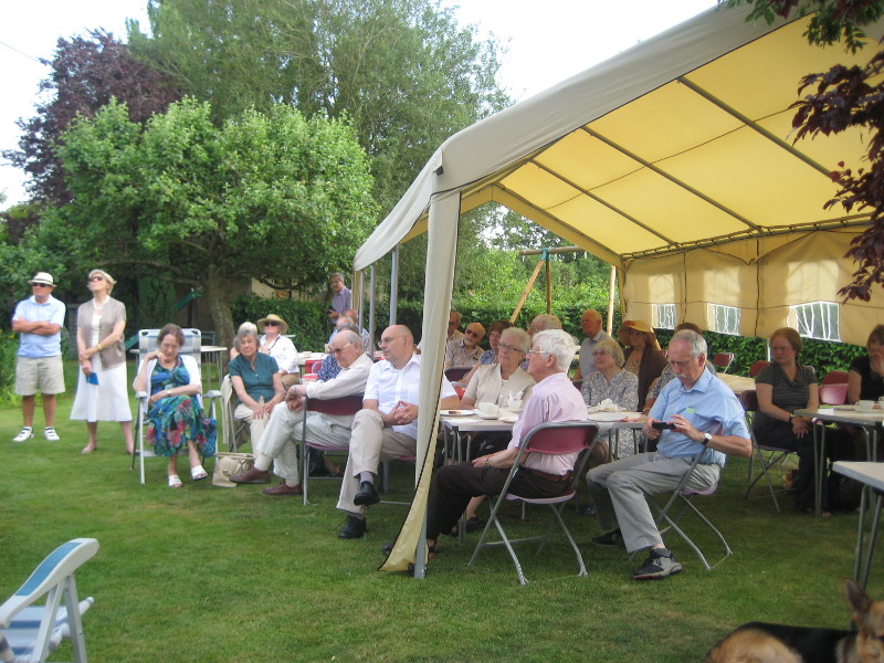 Listeners and volunteers enjoy tea and cakes in the marquee.